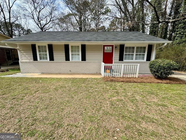 ranch-style house with a front lawn, brick siding, and covered porch