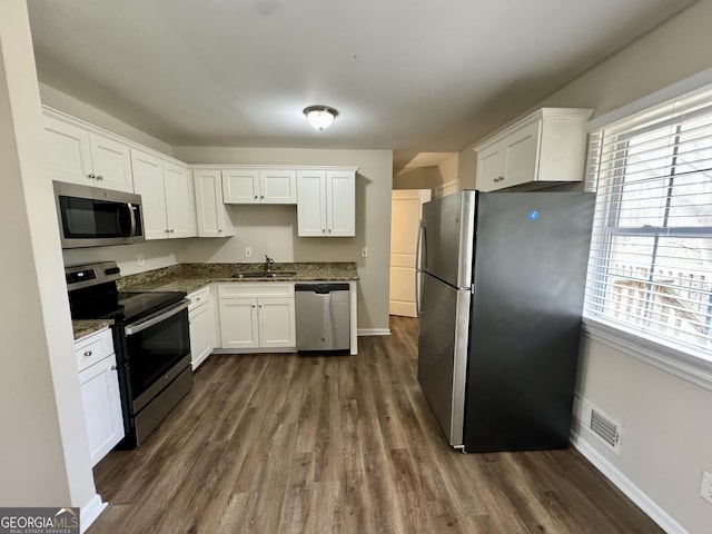 kitchen featuring appliances with stainless steel finishes and white cabinets