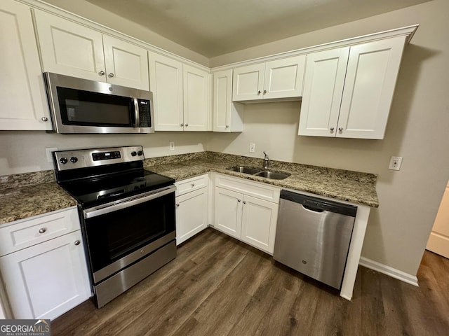 kitchen featuring a sink, dark wood-type flooring, white cabinetry, and stainless steel appliances