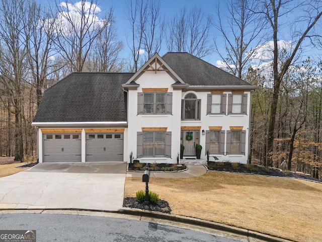 view of front facade with a shingled roof, concrete driveway, a front yard, stucco siding, and an attached garage