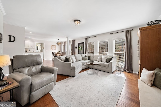 living area featuring crown molding, recessed lighting, wood finished floors, and baseboards