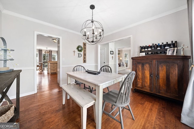 dining room featuring a chandelier, crown molding, and dark wood-type flooring