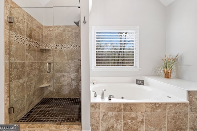 bathroom with a shower stall and a garden tub