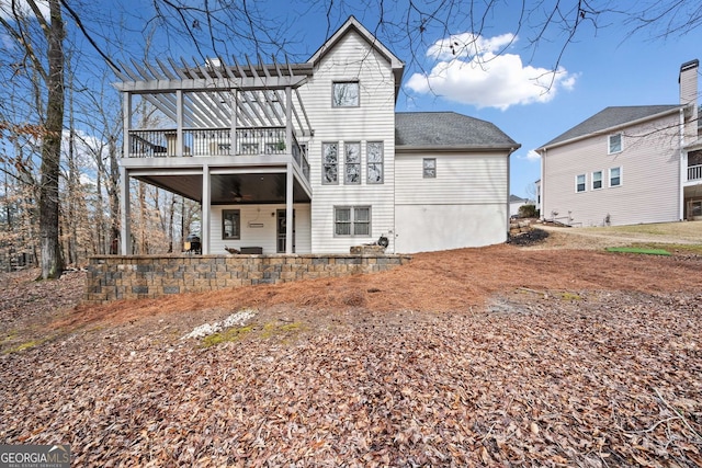 rear view of property featuring a deck and a patio area