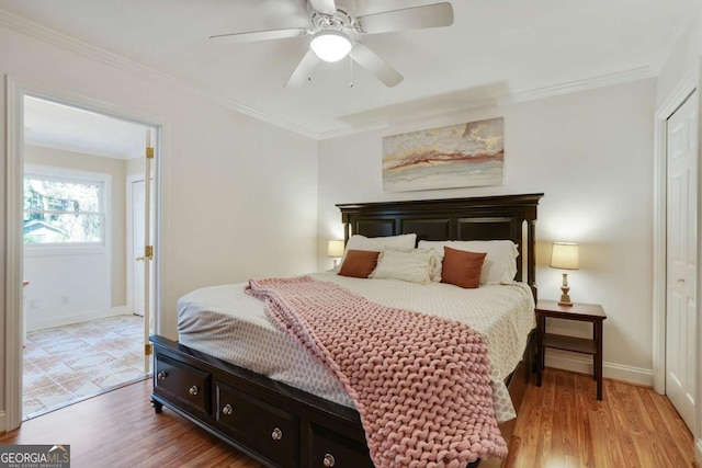 bedroom with baseboards, ornamental molding, a ceiling fan, and light wood finished floors