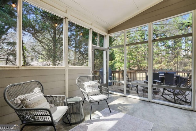 sunroom / solarium featuring vaulted ceiling