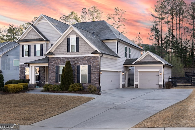 craftsman-style house featuring stone siding and driveway