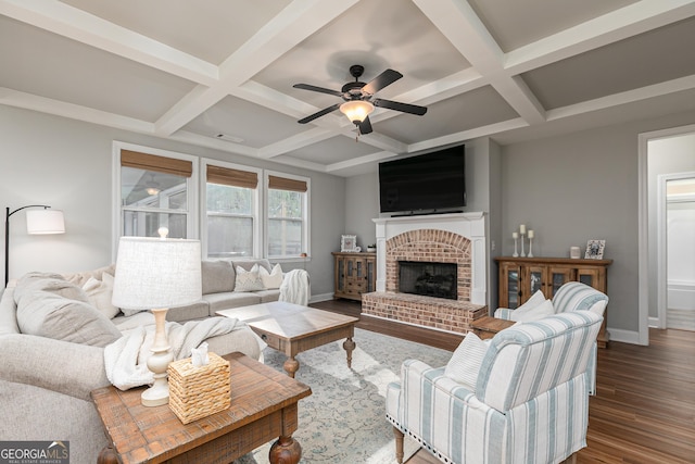 living area featuring baseboards, coffered ceiling, a brick fireplace, and dark wood-style floors