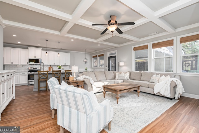 living area with wood finished floors, visible vents, coffered ceiling, beam ceiling, and recessed lighting