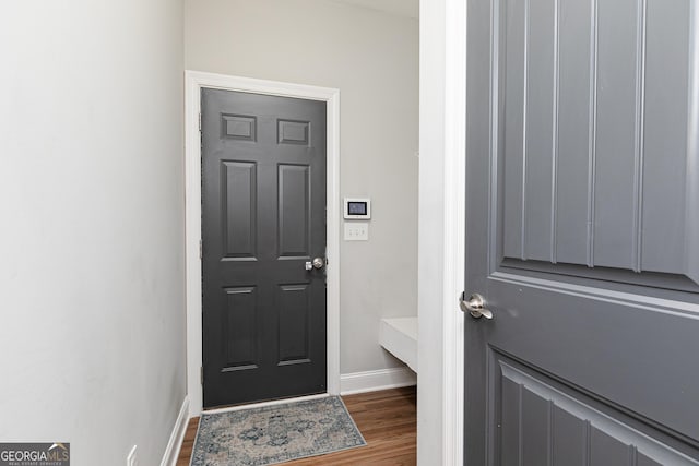 interior space with baseboards and wood finished floors