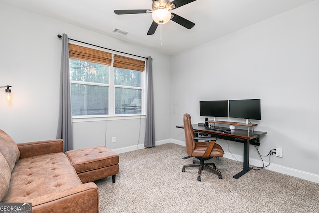 carpeted office featuring a ceiling fan, baseboards, and visible vents