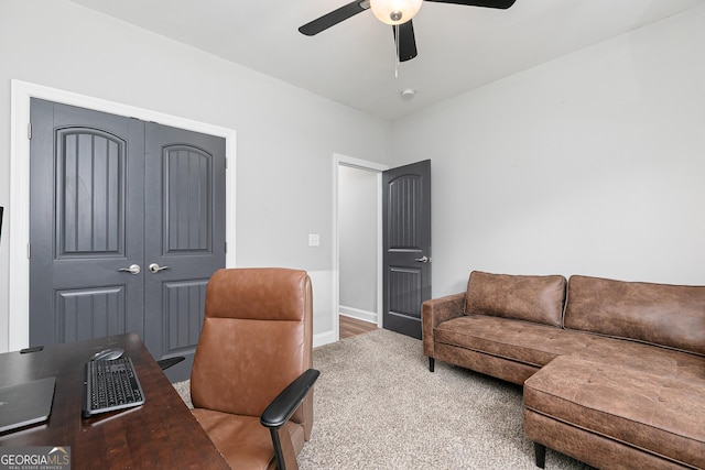 office area with baseboards and ceiling fan