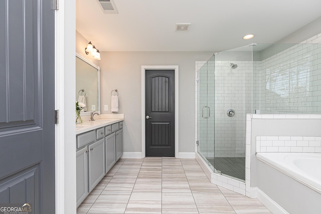 full bath with visible vents, a stall shower, a sink, double vanity, and a bath