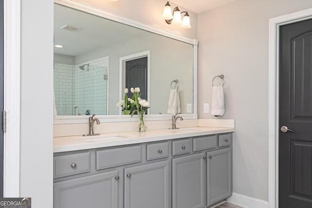 bathroom featuring a sink, visible vents, a stall shower, and double vanity