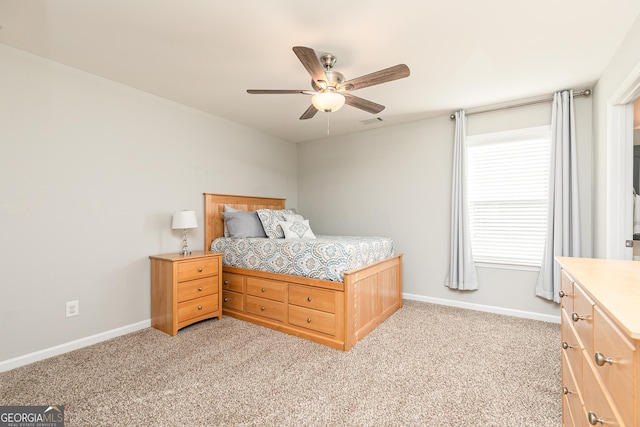 bedroom with a ceiling fan, visible vents, baseboards, and light carpet