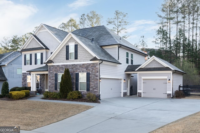 craftsman house with stone siding, driveway, and an attached garage