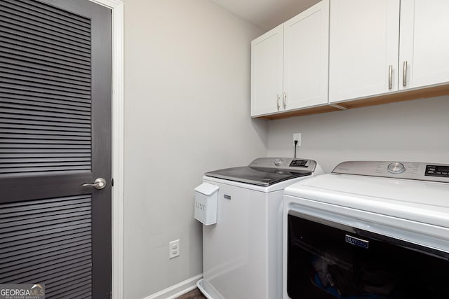 laundry room featuring cabinet space, baseboards, and separate washer and dryer