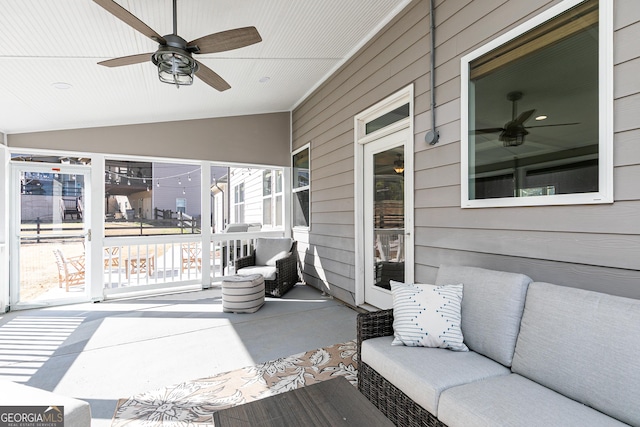 sunroom / solarium featuring lofted ceiling and ceiling fan