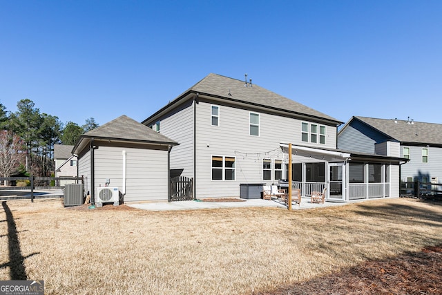 back of property with a lawn, central AC, fence, a sunroom, and a patio area