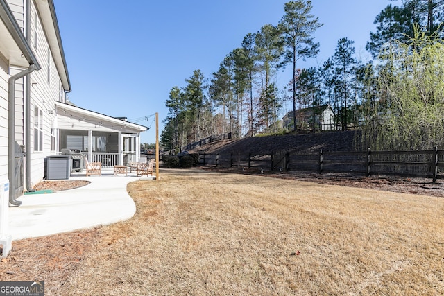 view of yard featuring a patio and fence