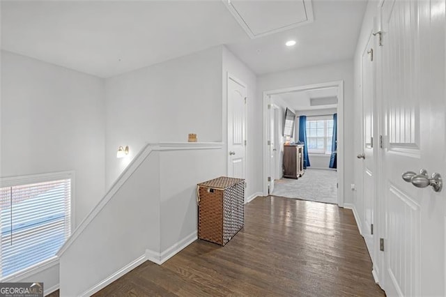 corridor featuring recessed lighting, baseboards, an upstairs landing, and wood finished floors