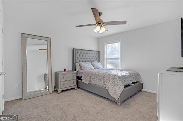 carpeted bedroom with baseboards and ceiling fan