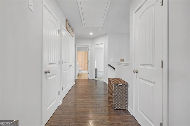 hallway featuring dark wood finished floors, recessed lighting, and attic access