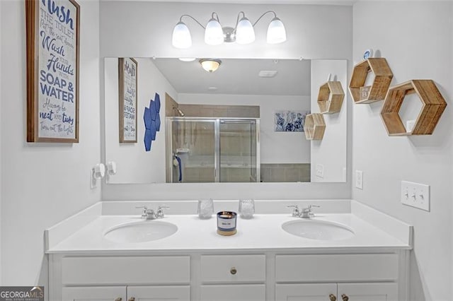 bathroom featuring a sink, double vanity, and a shower stall