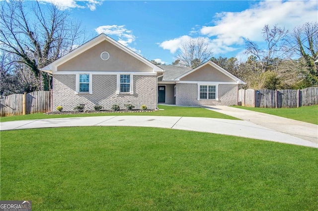 ranch-style home featuring brick siding, driveway, a front yard, and fence