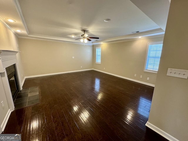 unfurnished living room featuring visible vents, baseboards, a tiled fireplace, ornamental molding, and dark wood-style floors