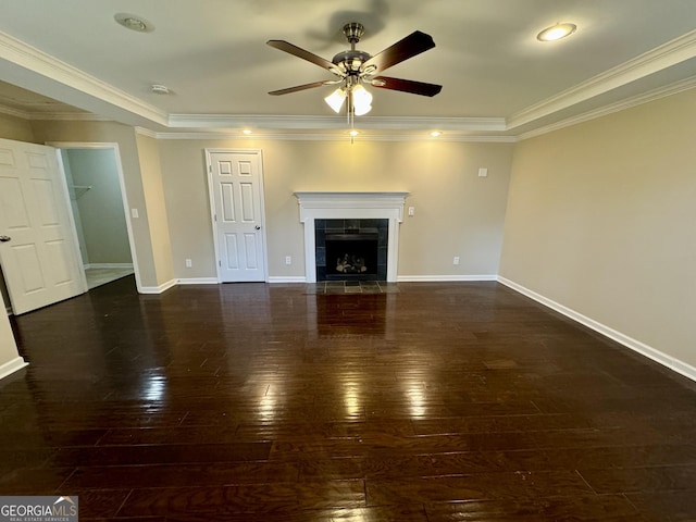 unfurnished living room with a ceiling fan, hardwood / wood-style floors, crown molding, baseboards, and a tile fireplace