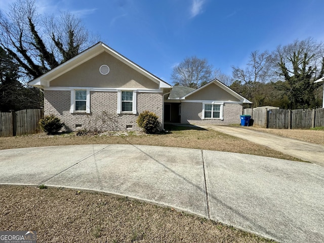 single story home with fence, stucco siding, concrete driveway, crawl space, and brick siding