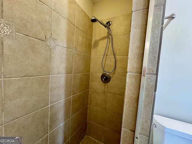 full bath featuring toilet and a stall shower