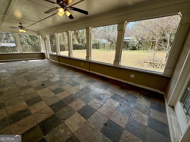 unfurnished sunroom featuring ceiling fan