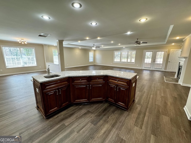 kitchen with a sink, open floor plan, and a fireplace