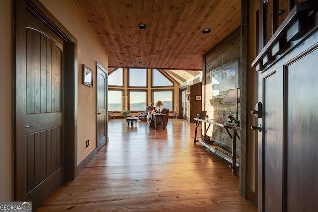 corridor featuring wood finished floors, wood ceiling, and vaulted ceiling