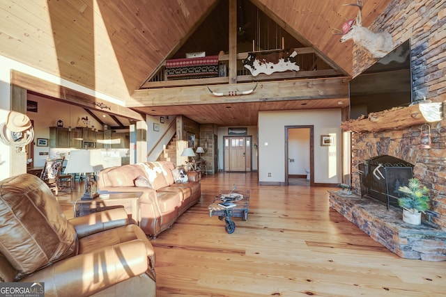 living room featuring a fireplace, wood ceiling, stairs, and wood finished floors