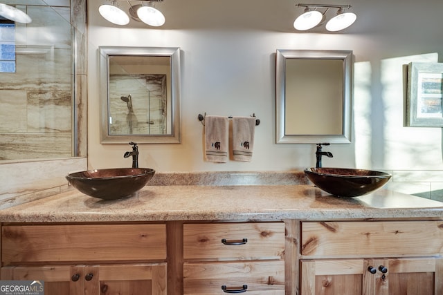 bathroom featuring a sink and double vanity