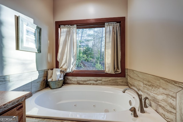 bathroom with a jetted tub and vanity