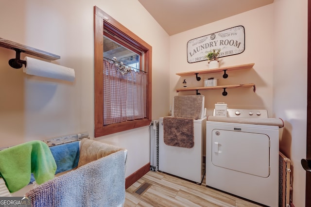 washroom featuring visible vents, baseboards, washer and clothes dryer, laundry area, and wood finished floors