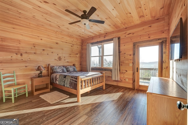 bedroom featuring access to exterior, wood walls, wood ceiling, and wood finished floors