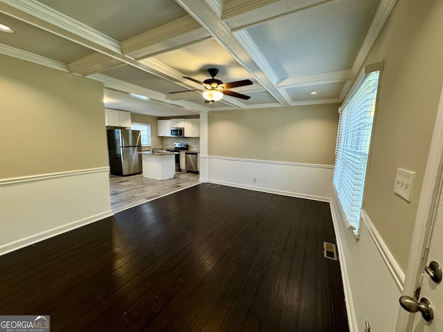 unfurnished living room featuring visible vents, ceiling fan, beamed ceiling, light wood-style floors, and coffered ceiling