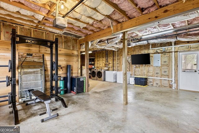 basement with electric panel and washer and clothes dryer