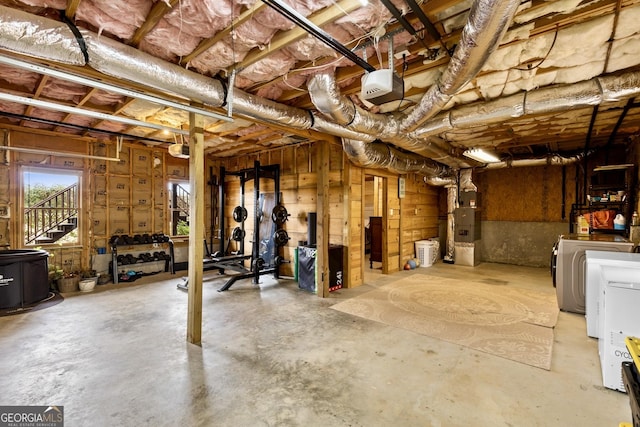 below grade area featuring heating unit and independent washer and dryer