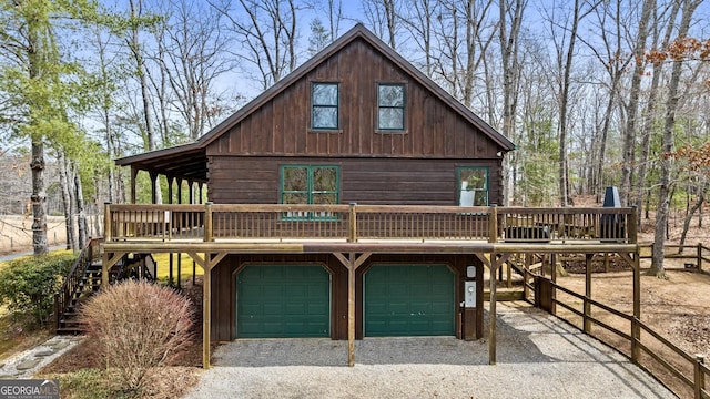 view of front facade featuring stairway, an attached garage, driveway, and a deck