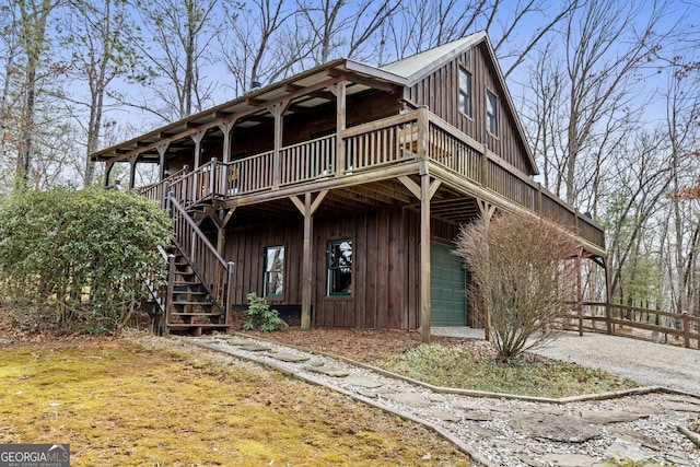 view of front facade featuring stairway and board and batten siding