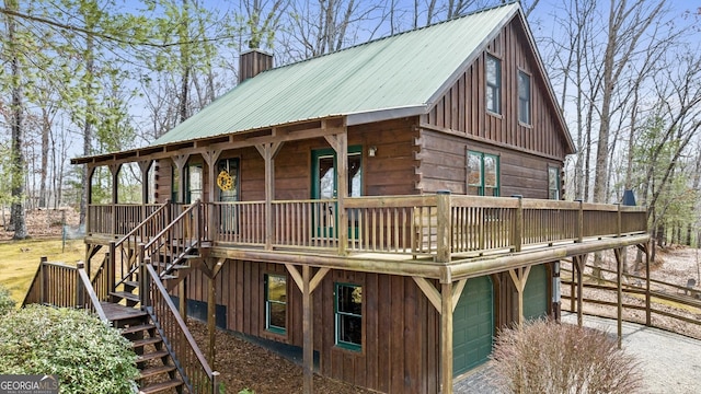 exterior space with metal roof, covered porch, a chimney, and stairs