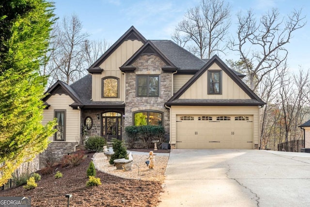 craftsman-style home featuring stone siding, board and batten siding, concrete driveway, and an attached garage