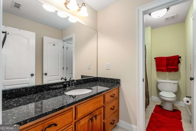 bathroom with vanity, toilet, visible vents, and tile patterned flooring