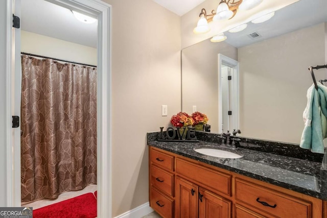 full bathroom featuring vanity, curtained shower, and visible vents